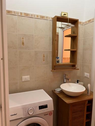 a bathroom with a washing machine and a sink at speZialhouse - Centro Storico & Cinque Terre in La Spezia