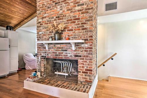 a brick fireplace in a living room with a chair at Spacious Family Home on Lake Marion with Boat Ramp! 