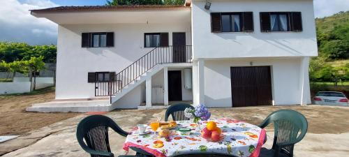 a table in front of a house at Quinta dos Castros Douro in Baião