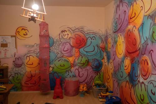 a room with a wall covered in graffiti at BurgenLandhaus in Gols