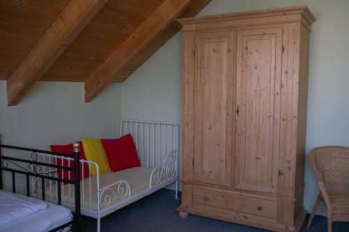a room with a crib and a wooden cabinet at BurgenLandhaus in Gols