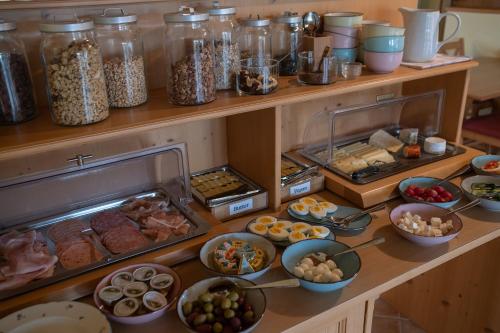 a buffet filled with lots of different types of food at BurgenLandhaus in Gols