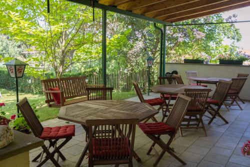 an outdoor patio with tables and chairs and trees at BurgenLandhaus in Gols