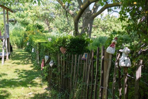 a wooden fence with some items on it in a garden at BurgenLandhaus in Gols