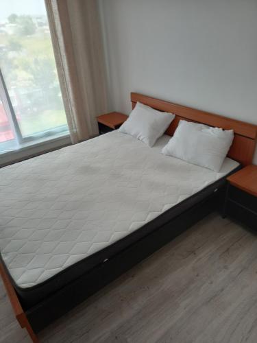 a bed in a bedroom next to a window at Twins Residence 2 APART HOTEL Ap 3 2 rooms in Chiajna