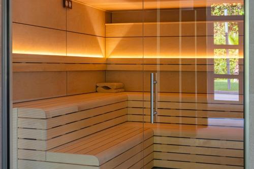 a sauna with a bench in a room at Aparthotel Costa Encantada in Lloret de Mar