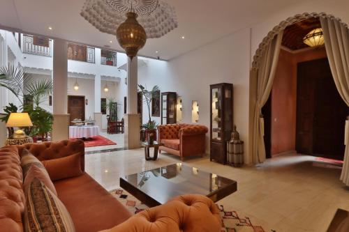 a living room with a couch and a table at Riad Mandana & Spa in Marrakesh