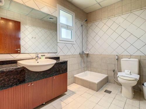 a bathroom with a sink and a toilet and a sink at Key View - Silicon Star in Dubai