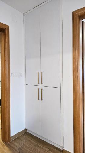 a white closet with white cabinets in a room at Holiday Home Natura with private pool in Mostar