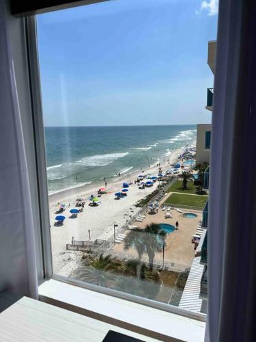 a view of a beach with umbrellas and the ocean at Ocean House 1806 in Gulf Shores