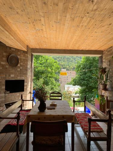 a room with a table and chairs on a patio at Mountain View Guesthouse in Dilijan