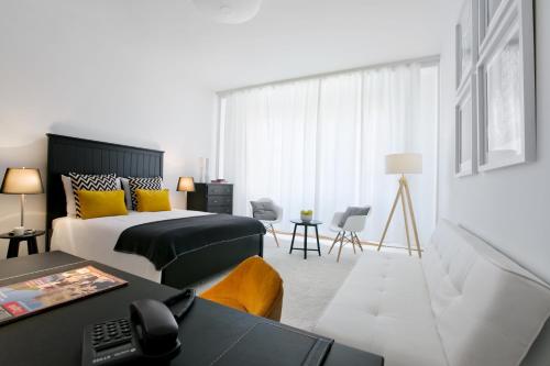 a hotel room with a bed and a desk at Angel Main Square Center Zagreb in Zagreb
