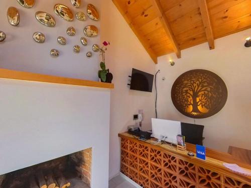 a room with a fireplace and a desk with a tree on the wall at Hacienda Valentino in San Cristóbal de Las Casas