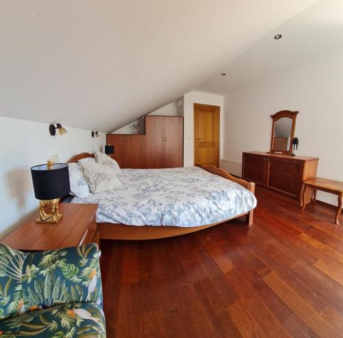 a bedroom with a large bed and a couch at Villa Magnetic in Baošići