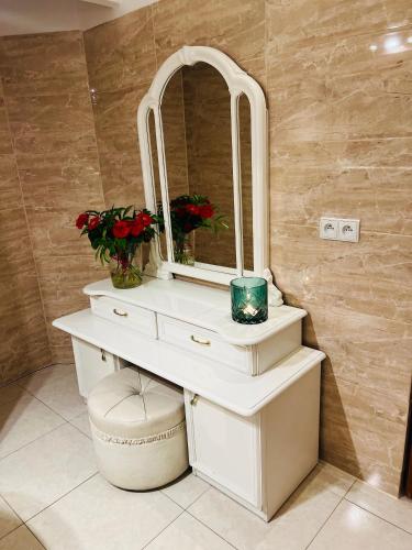 a bathroom with a white sink with a mirror at Nostalgia Poganice in Potęgowo