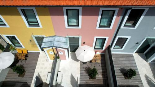 a colorful building with a street light and an umbrella at Boavista Luxury Villas in Porto