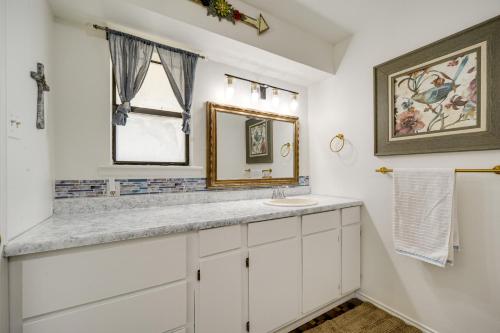 a bathroom with a sink and a mirror at McQueeney Home with Grill about 10 Mi to New Braunfels in McQueeney