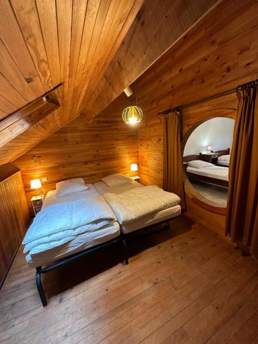 a bedroom with a bed in a wooden room at Villa Janchrisma MontDore 11pers in Le Mont-Dore