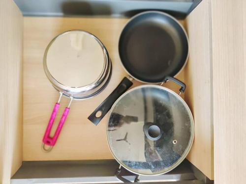 a table with two frying pans and a mirror at Paris Suite By Hey Studio's in Ghaziabad