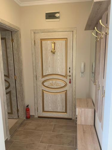 a large door in a room with a tile floor at Happy smiles in Pomorie