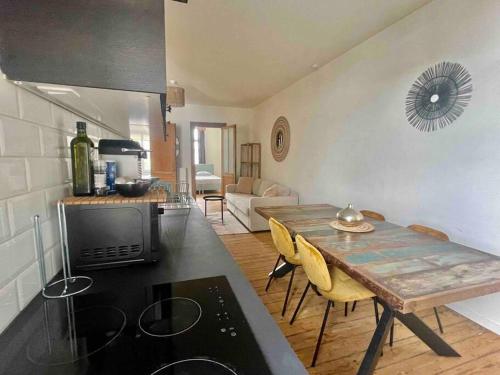 a kitchen and living room with a wooden table in a room at Spacious 2BDR Apartment, Antwerp center in Antwerp