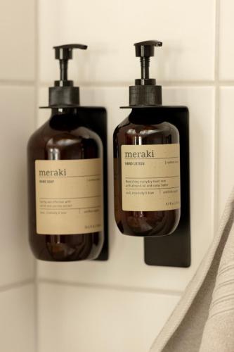 two bottles of soap on a shelf in a bathroom at Victoria's Home - luxurious penthouse in Saas-Fee