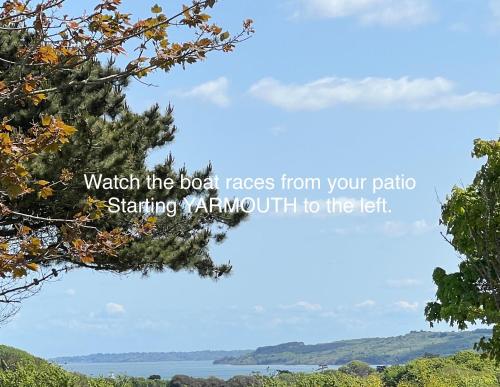 watch the boat races from your patio starting xantmuth to the left tree at VALLEY VIEW self-catering coastal bungalow in rural West Wight in Freshwater