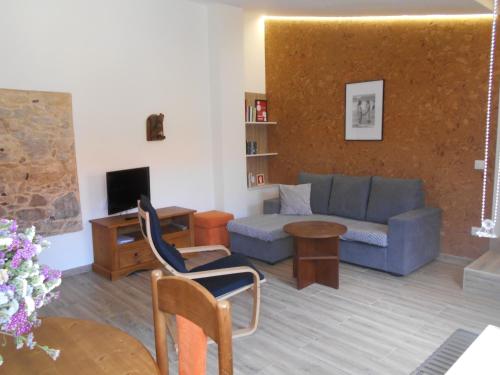 a living room with a couch and a table at Casa do forno in Salir de Porto