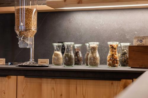a group of glass vases sitting on a counter at Hotel Garni Chesa Mulin in Pontresina
