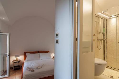 a bedroom with a bed and a bathroom with a shower at Umbrian Concierge - Villa Imbriani in Perugia