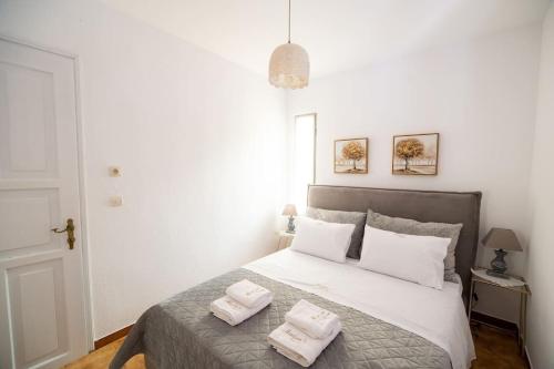 a bedroom with a bed with two towels on it at Μariza's escape in Afissos