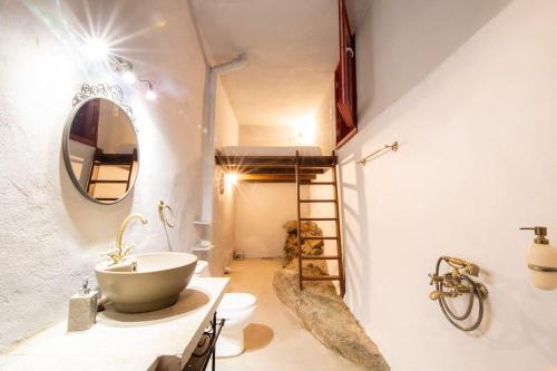 a bathroom with a sink and a mirror at Μariza's escape in Afissos