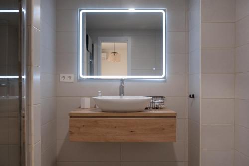 a bathroom with a sink and a mirror at Victoria's Home modern and cosy 2 bedroom apartment in Málaga