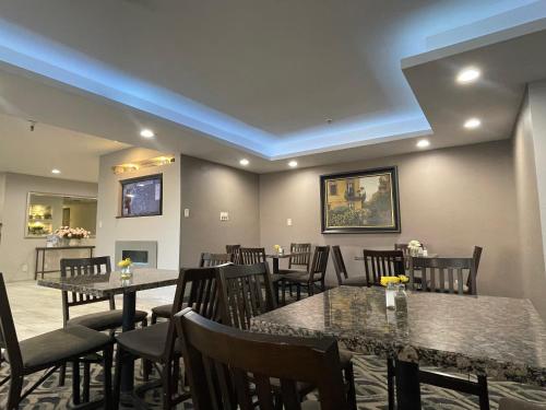 a restaurant with tables and chairs in a room at La Quinta Inn and Suites by Wyndham Cincinnati North in Springdale