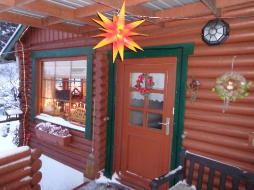 a house with a christmas star hanging above the door at Ferienhaus Sachse in Pockau