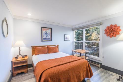 a bedroom with a bed and a window at Mountainside Inn 103 Hotel Room in Telluride