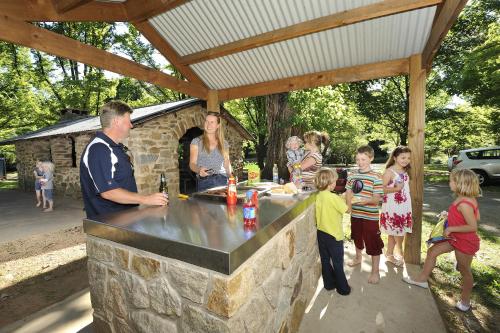 a group of children standing around a stone bar at NRMA Bright Holiday Park in Bright