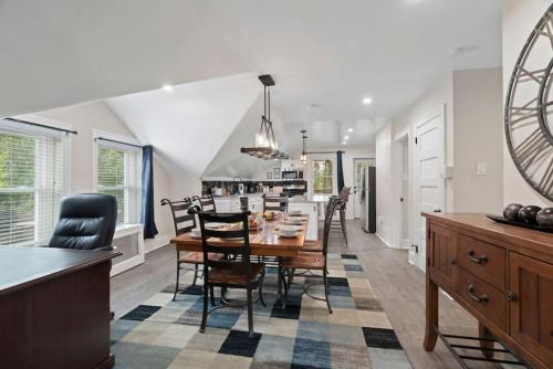 a dining room and kitchen with a table and chairs at Spacious Home King Beds Gym Deck Games Parking AC in Narberth