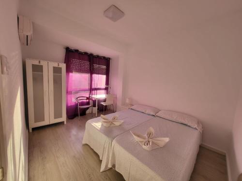 una camera da letto con un letto con un arco sopra di Apartamento Cálido a Cartagena