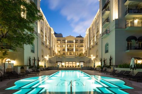 a swimming pool in front of a building at night at Palácio Tangará, Oetker Hotels in Sao Paulo