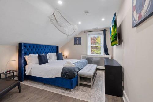 a bedroom with a blue bed and a window at 5 Star Penthouse King Deck AC Train 