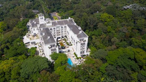 an aerial view of a large building in the forest at Palácio Tangará - an Oetker Collection Hotel in São Paulo