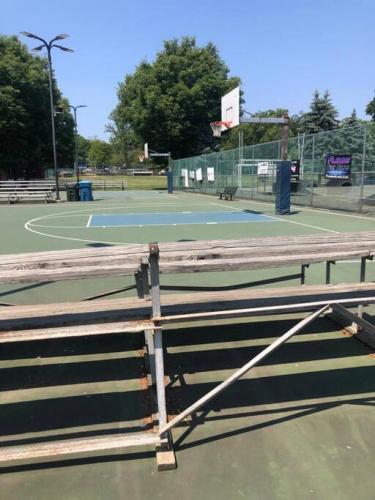 a tennis court with a basketball hoop at 5 Star Penthouse King Deck AC Train in Narberth