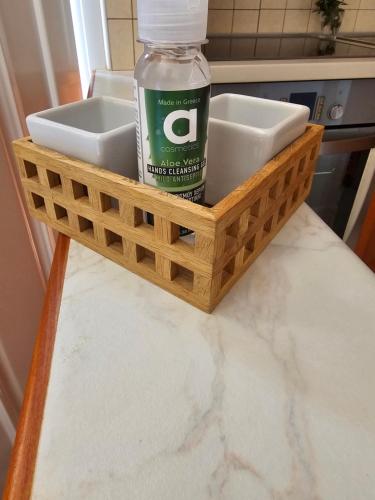 a wooden tray with a bottle of water and a sink at Athene place 1 in Rodhiá