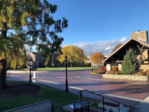 a park with a parking lot with a building at 5 Star Penthouse King Deck AC Train in Narberth