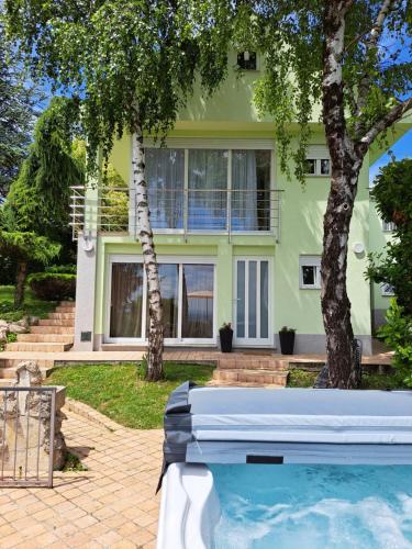 a house with a swimming pool in front of a house at Vlaškovec Experience in Plešivica