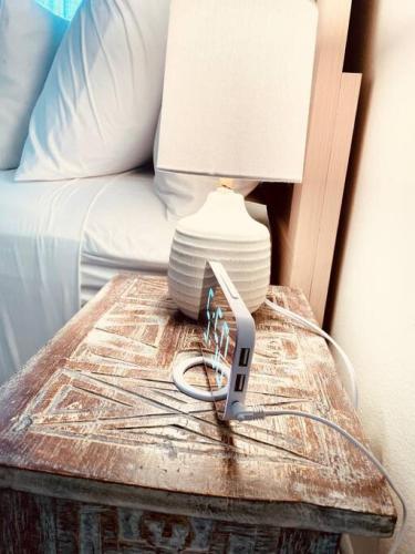 a lamp on a table next to a bed at Zen Haus Garden Retreat, prime location, Luxe amenities in Eugene