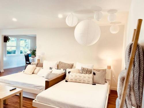 a living room with two white couches and a table at Zen Haus Garden Retreat, prime location, Luxe amenities in Eugene