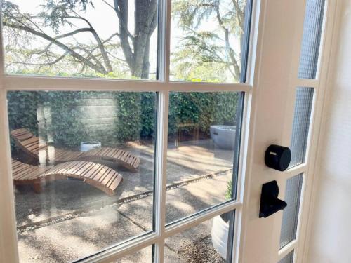 a view of a patio through a window at Zen Haus Garden Retreat, prime location, Luxe amenities in Eugene
