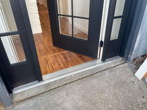an open door of a house with a wooden floor at Zen Haus Garden Retreat, prime location, Luxe amenities in Eugene